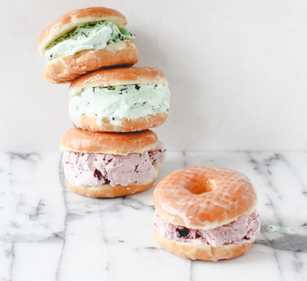 Close Up Still Life of Gourmet Double Scoop Ice Cream Sandwich with Variety  of Flavors Served on Donut with Red Berry Sauce Served on Wooden Paddle  Stock Photo - Alamy