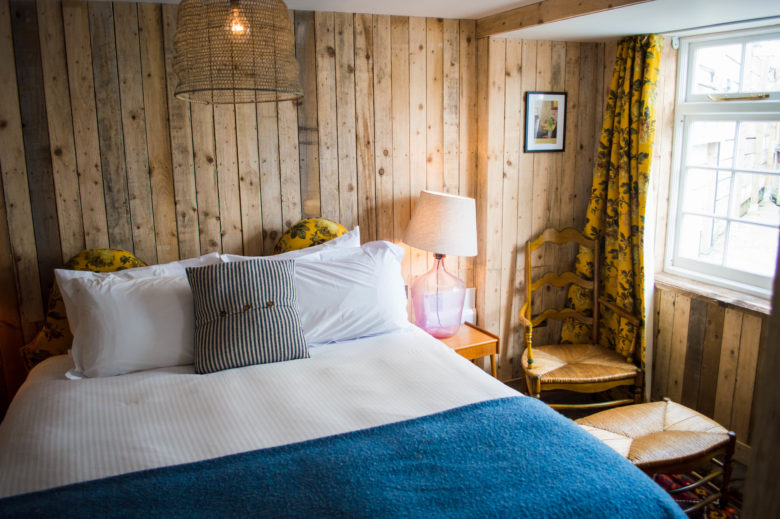 The downstairs bedroom with wood panelled walls