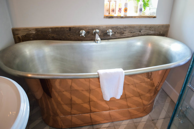The large metal bathtub in the bathroom upstairs