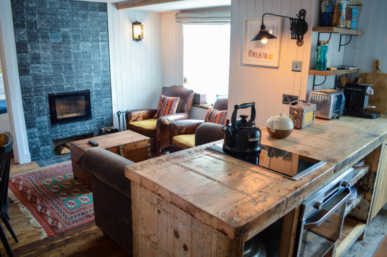 The open-plan kitchen and the sitting area with fireplace
