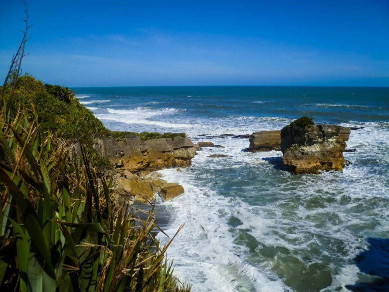 Waves crashing against cliffs in New Zealand