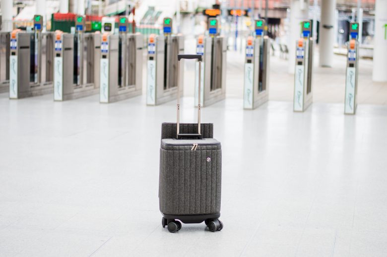 Suitcase in front of ticket barriers at a train station
