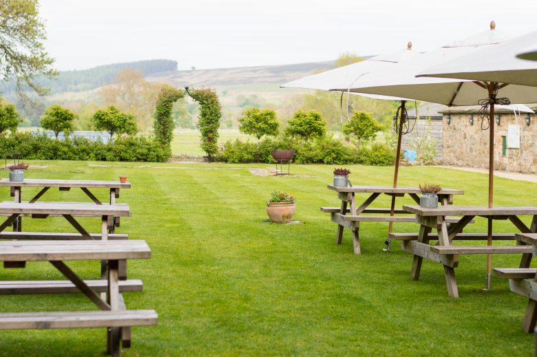 The gardens of The Lord Crewe Arms, looking out to the hilly scenery beyond
