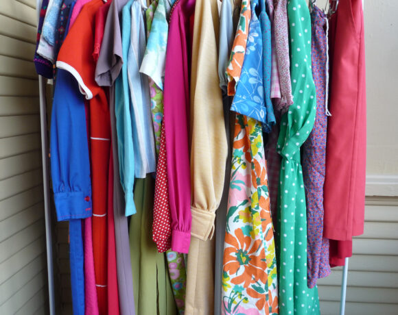 Summer clothes hung up in a row on a rack