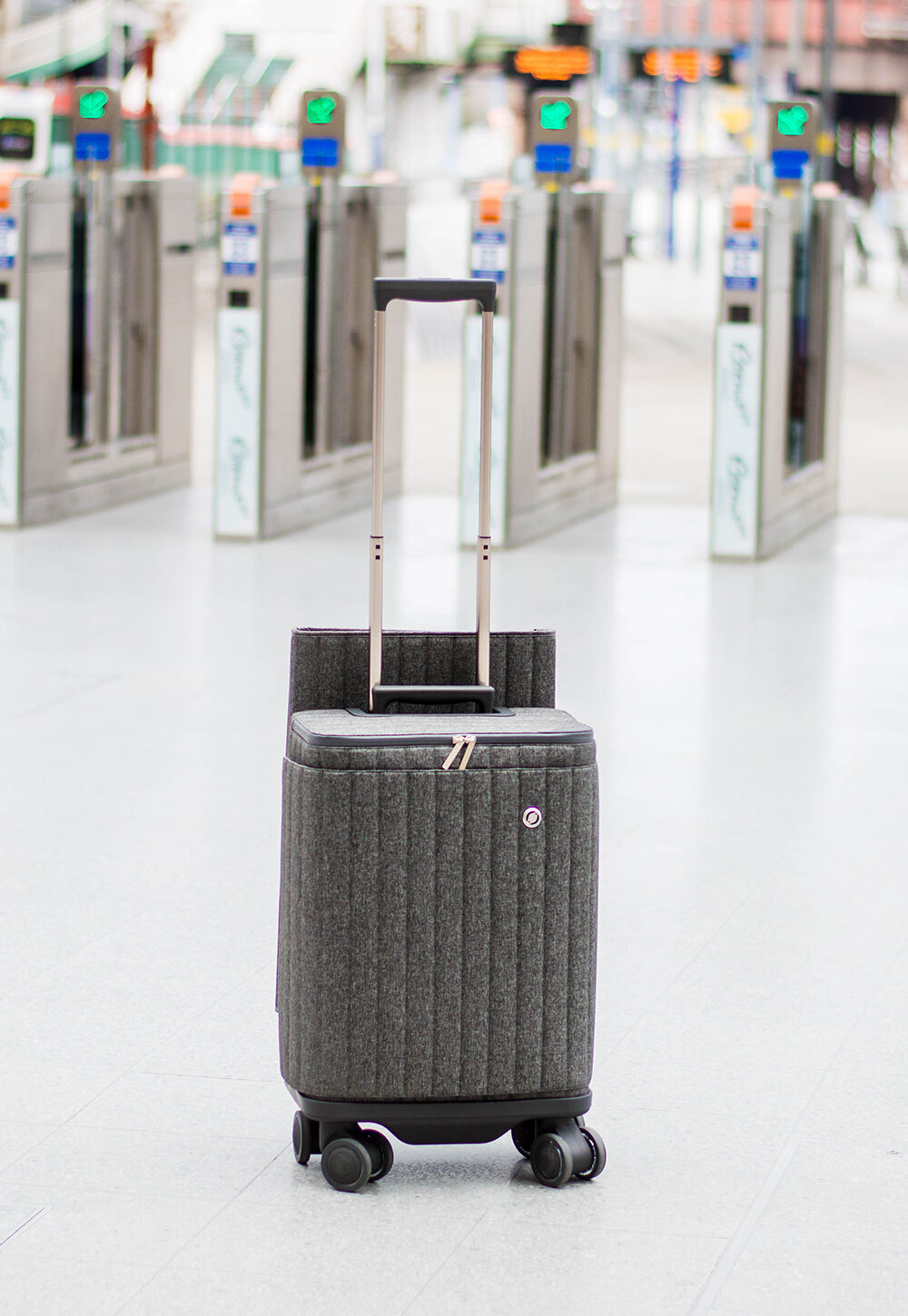 Suitcase sitting in front of the automatic gates at a train station