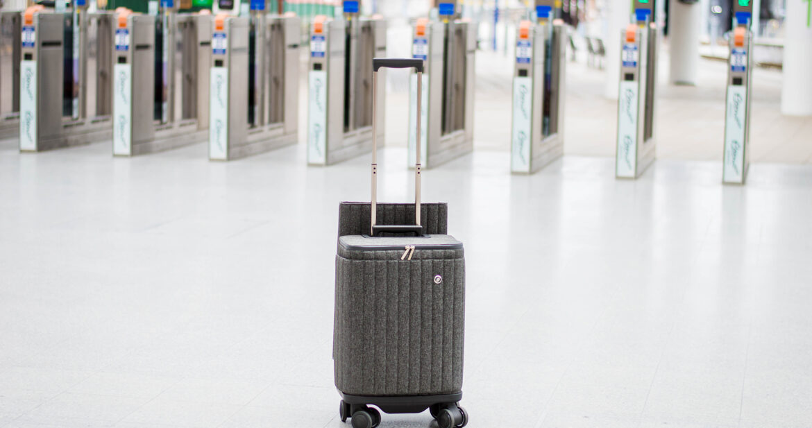 Suitcase sitting in front of the automatic gates at a train station