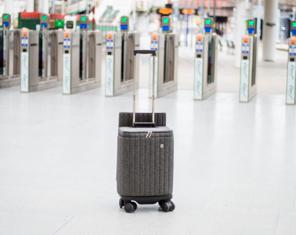 Suitcase sitting in front of the automatic gates at a train station
