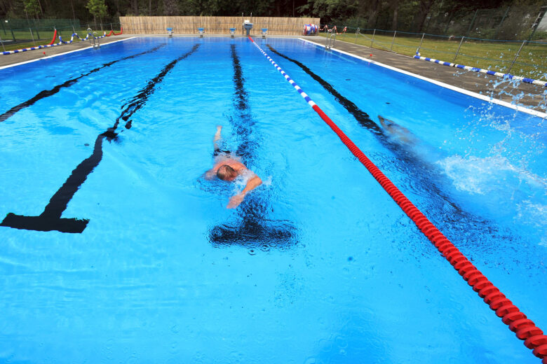 swimmer swimming laps in an outdoor pool