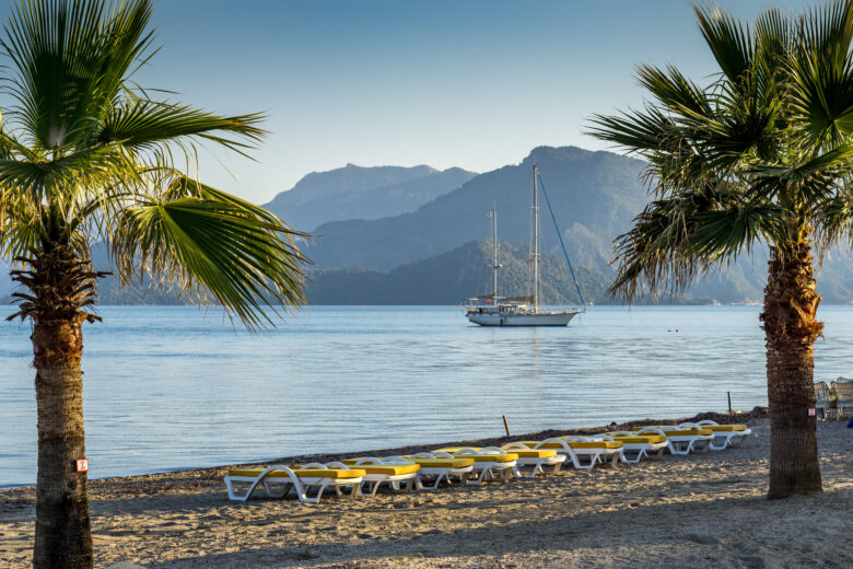 beach in Marmaris, Turkey with sailboat in the distance 