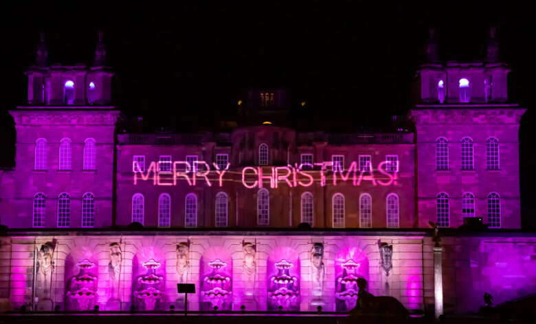 A 'Merry Christmas' sign illuminated on the front of Blenheim Palace