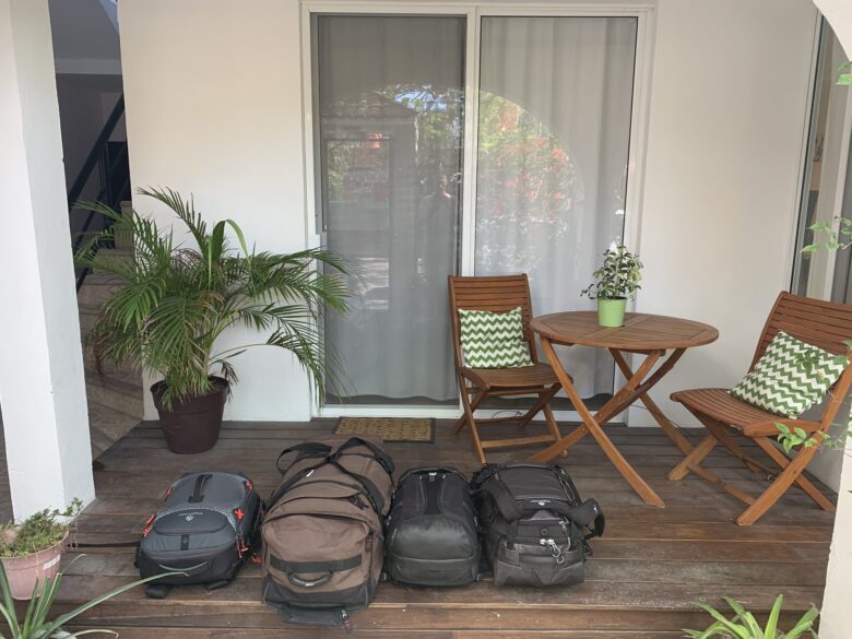 Backpacks laid out on a porch