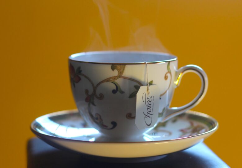 cup of tea on gold background with steam