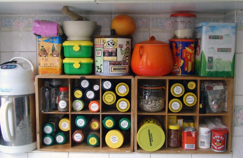 Organised bottles and canisters filled with spices and kitchen ingredients