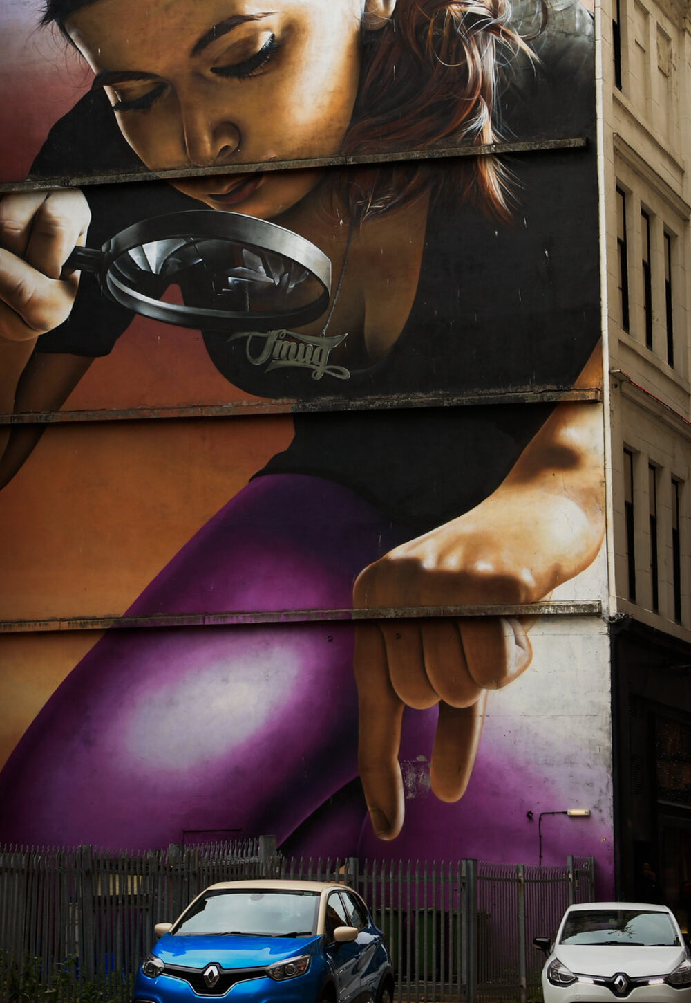 street art of woman inspecting cars with magnifying glass.