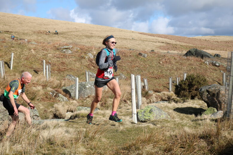 runner crests a hill in the countryside