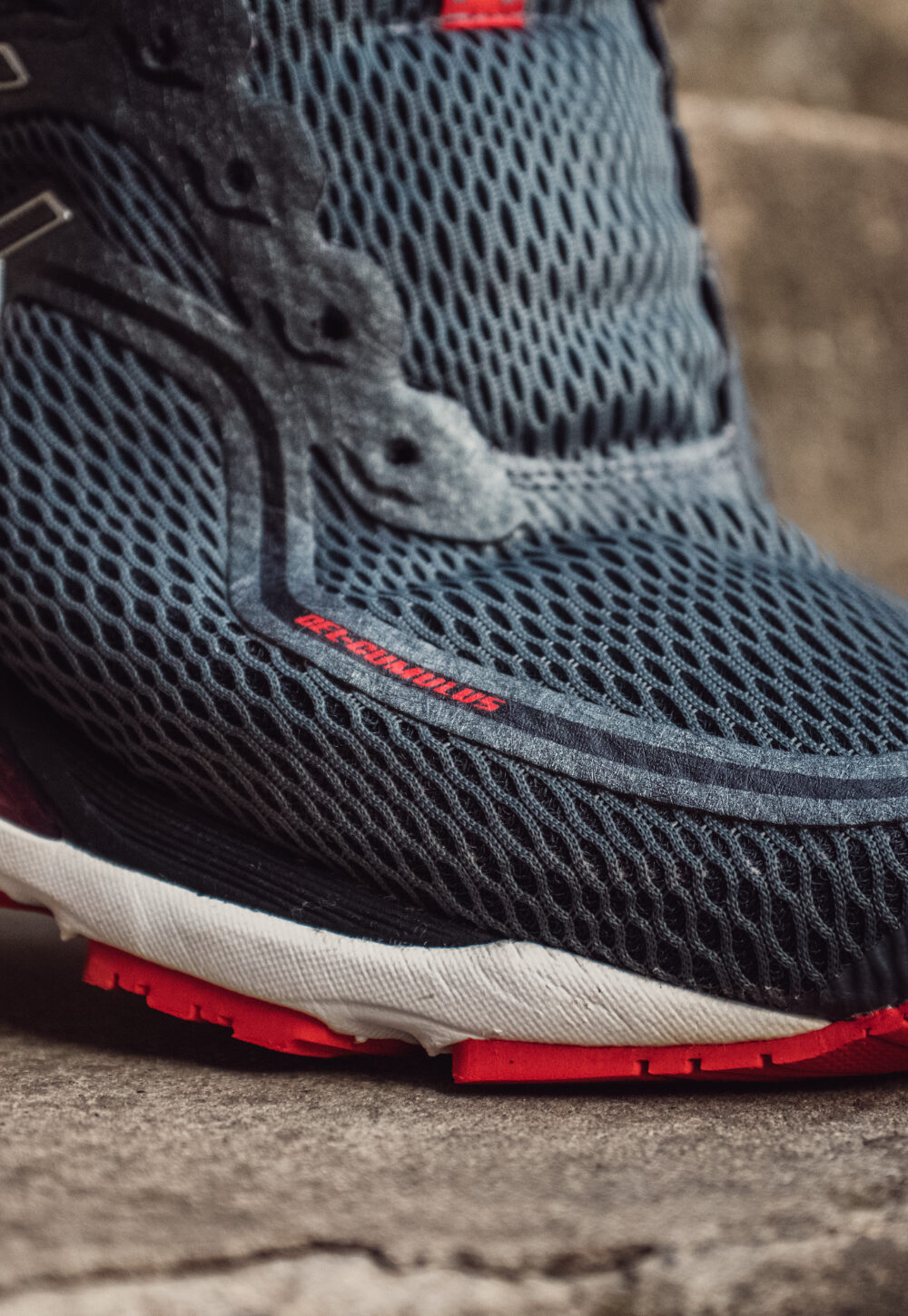 grey running shoe on a strap.