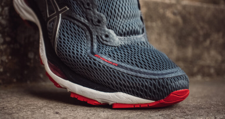 grey running shoe on a strap.