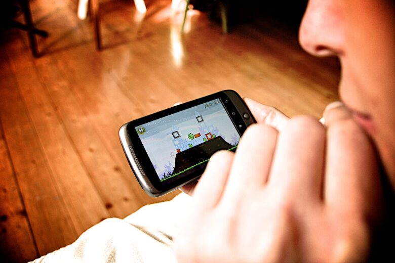A woman playing a game on her mobile phone