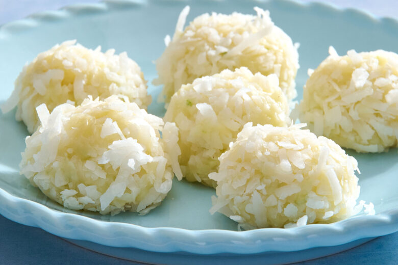 Coconut truffles with lemon and lime sitting on a plate