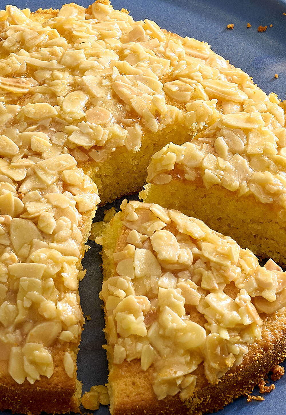 A plate of Swedish almond cake with two slices cut into it