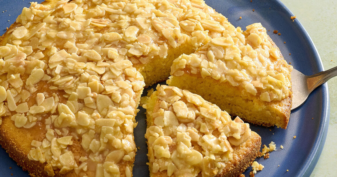 A plate of Swedish almond cake with two slices cut into it