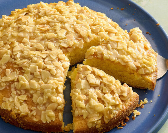A plate of Swedish almond cake with two slices cut into it