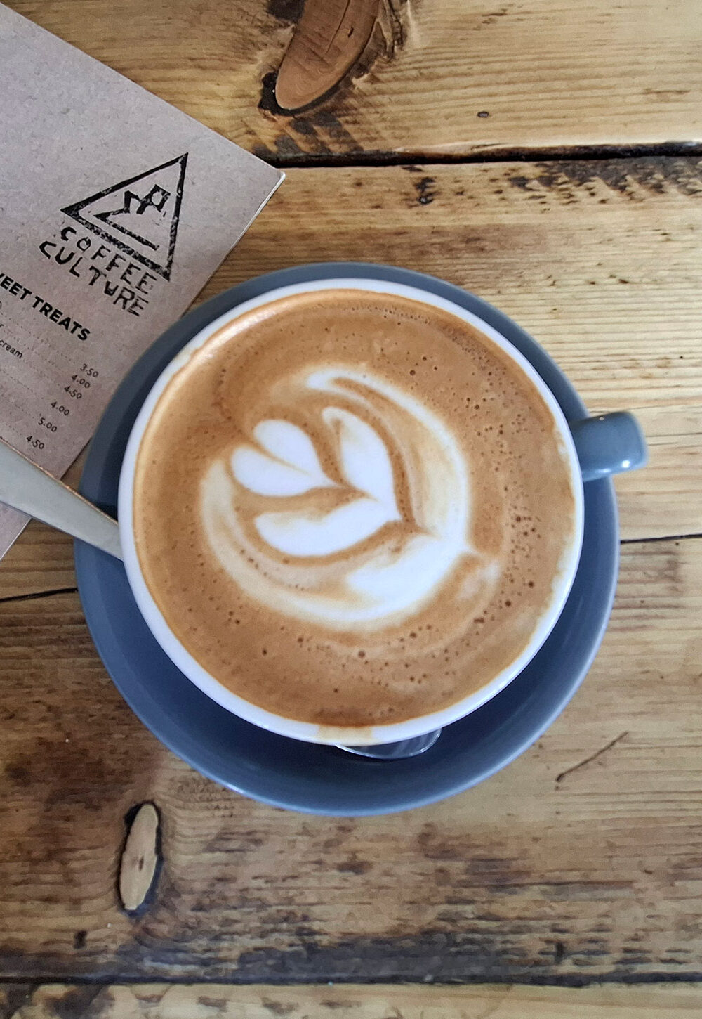 Overhead view of a coffee on a wooden table at Coffee Culture in York