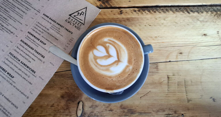Overhead view of a coffee on a wooden table at Coffee Culture in York