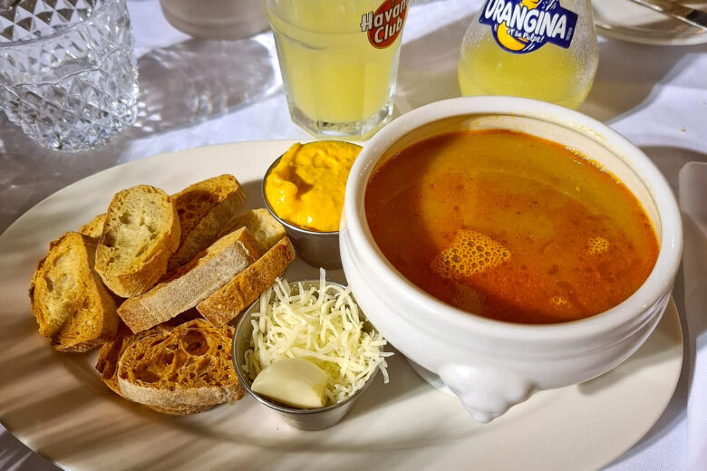 A bowl of bouillabaisse with croutons, rouille and cheese served at Chez Madie Les Galinettes in Marseille