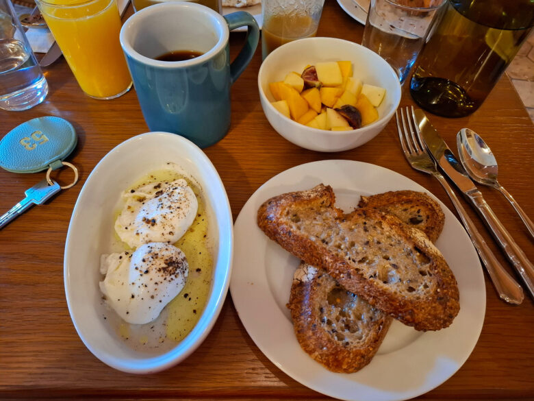Bread, poached eggs and fresh fruit served at the Hotel Amista breakfast