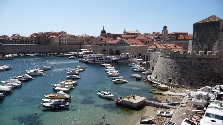 Sailboats lined up in Dubrovnik's old town harbour