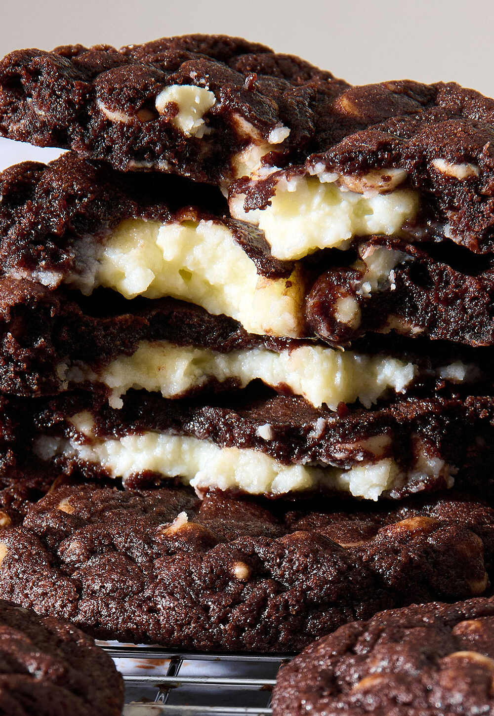 Closeup shot of a stack of double chocolate cheesecake cookies broken in half
