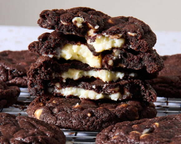 Closeup shot of a stack of double chocolate cheesecake cookies broken in half